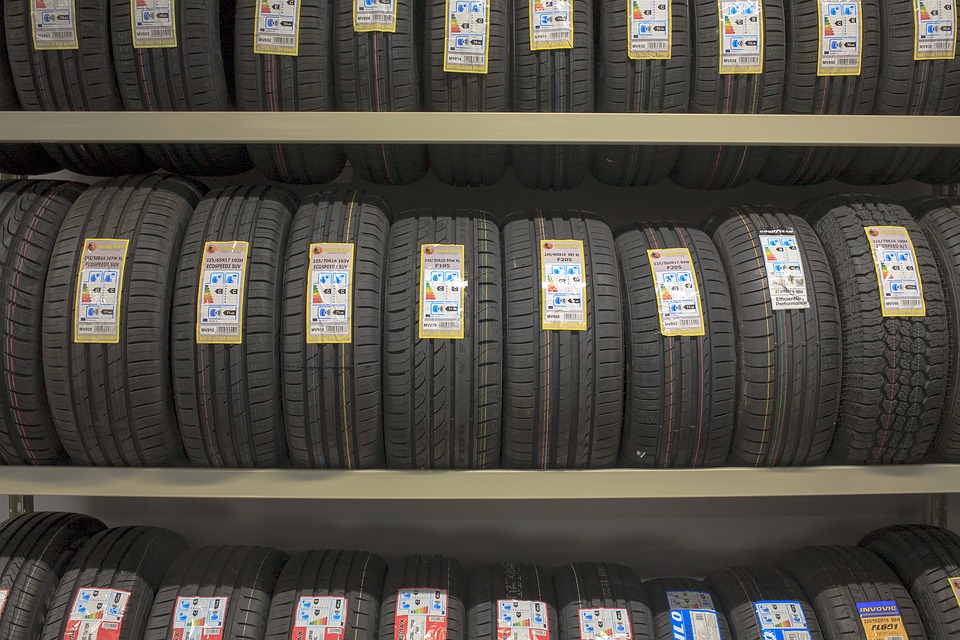 New tyres with price labels on a shop rack